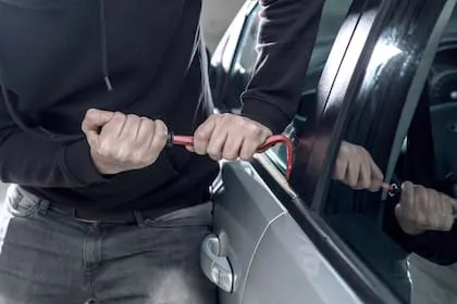 auto-thief-in-black-balaclava-trying-to-break-ZAL4GFCGWFFYVAFMUEPB5GCSSE